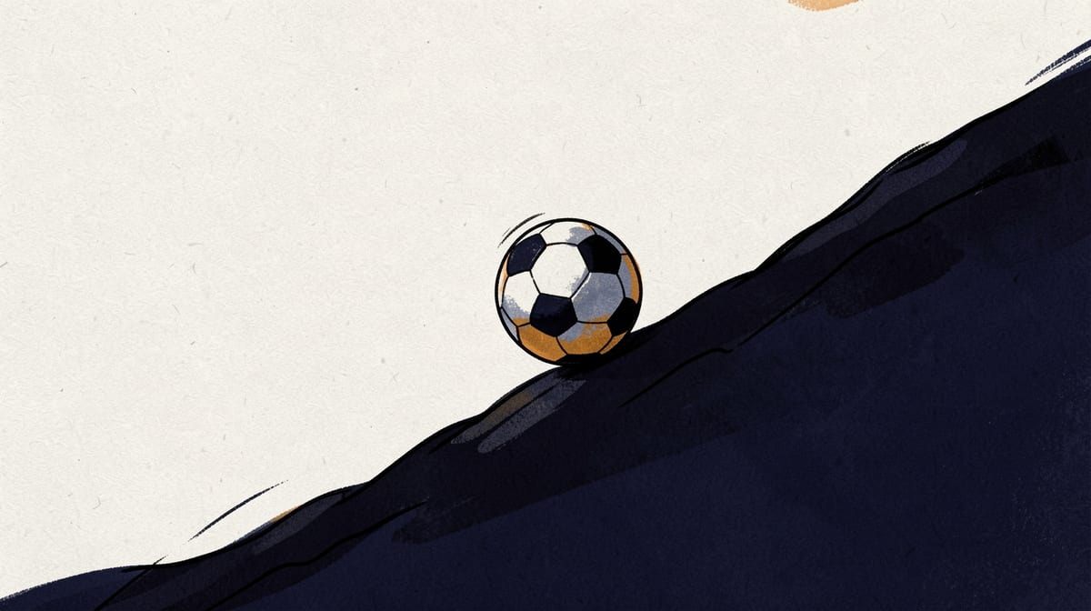A ball rests against an invisible barrier on an uphill slope, having stopped mid-roll while still touching the surface.